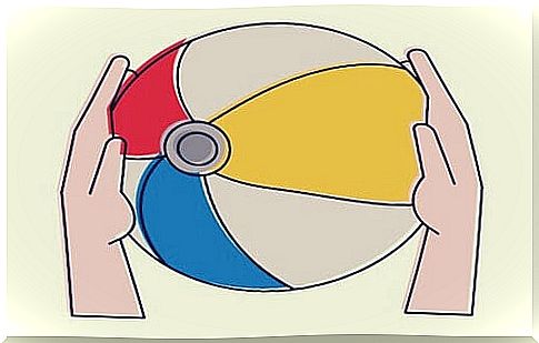 Beach ball metaphor, colored ball between two hands