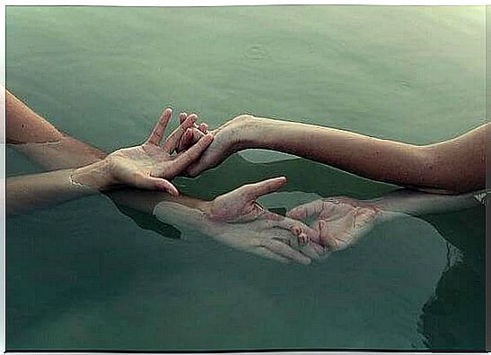 hands intertwined in the water