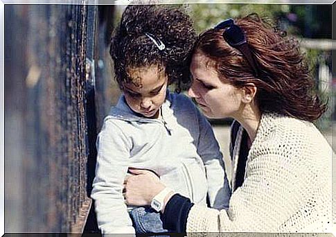 Mother hugs her daughter