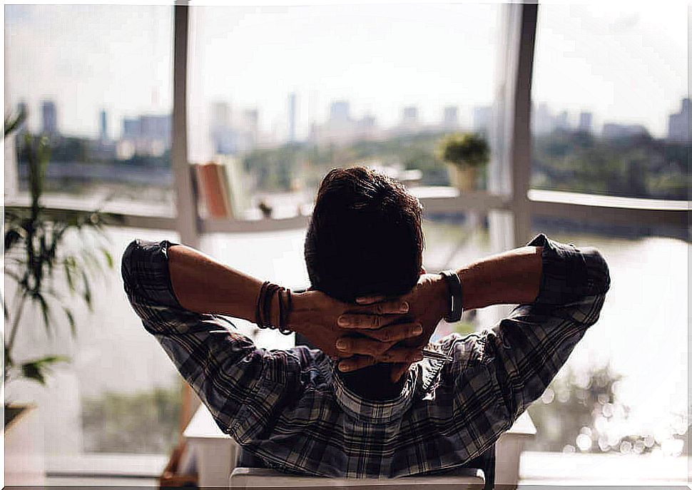 Man relaxing in front of window