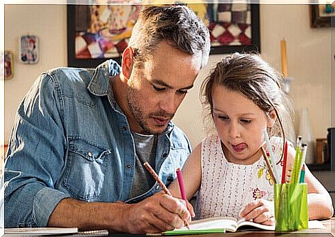 Father helps daughter with homework