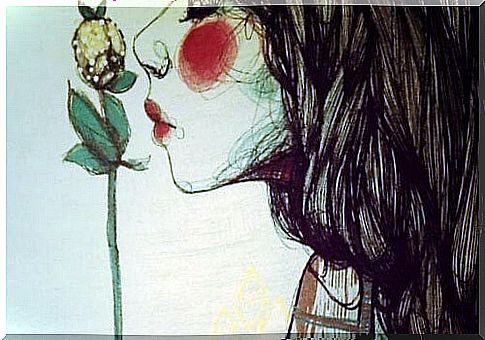 woman kissing flower