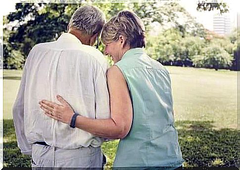 Mature couple strolls in the park