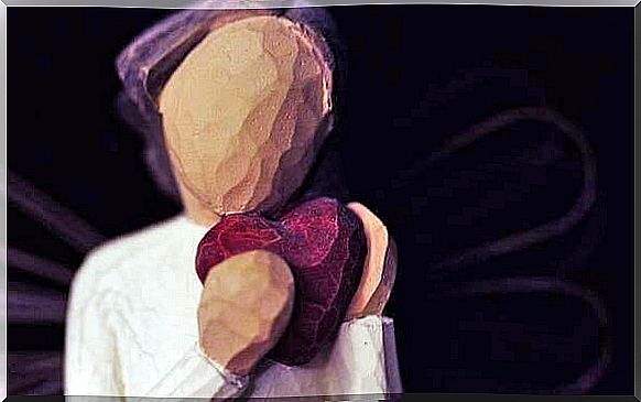 Wooden statue with a heart