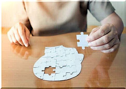 Woman doing a puzzle depicting a man's head.