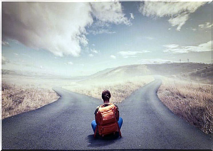 Maintaining control even under pressure, woman with backpack sitting at a crossroads