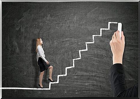 Woman walks up ladder drawn on chalkboard