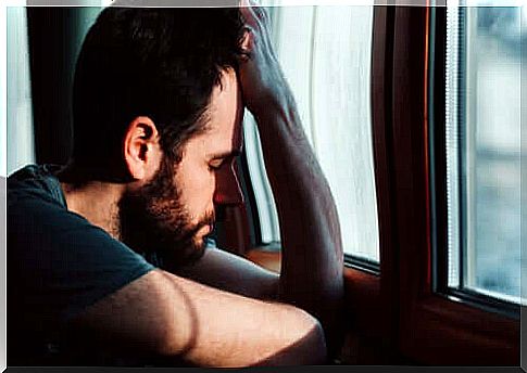 Depressed man leaning on his hand