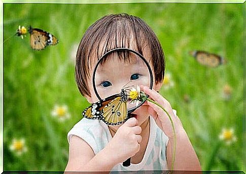 Little girl with magnifying glass.