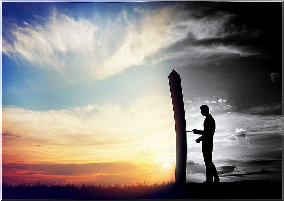 Silhouette of man with key in front of door of change