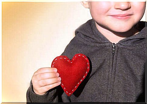 Child with cloth heart in hand as a symbol of children's emotional development