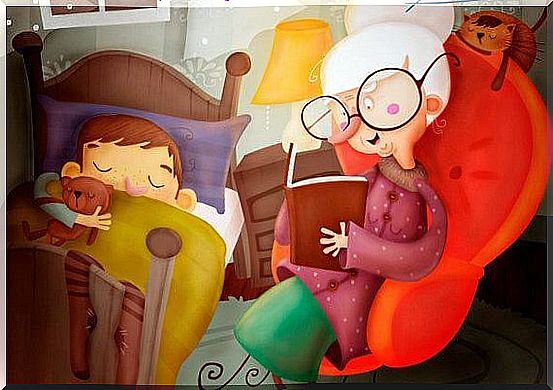 grandmother reads a fairy tale to her sleeping grandson