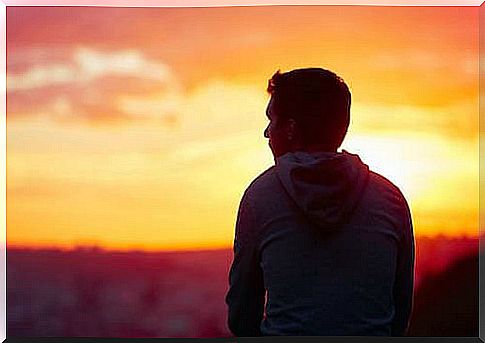 Pensive man watching a sunset.